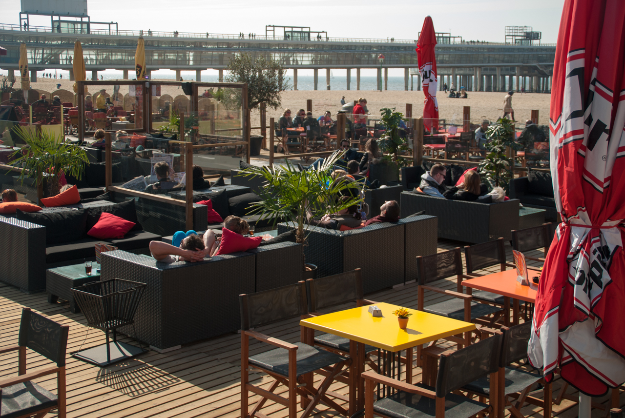 Terras van beachclub met maatkussens en loungeplekken